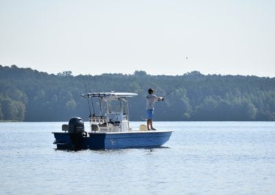 man fishing off of a boat